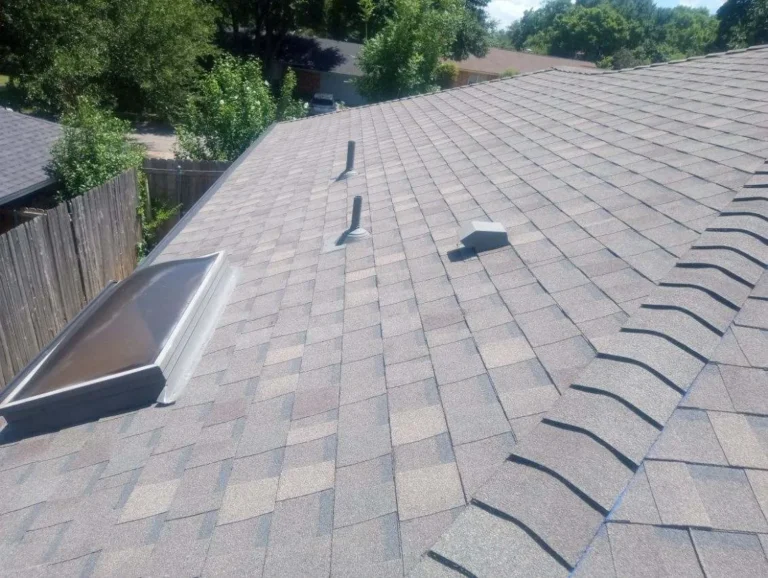 Completed roof showing shingle courses and ridge caps