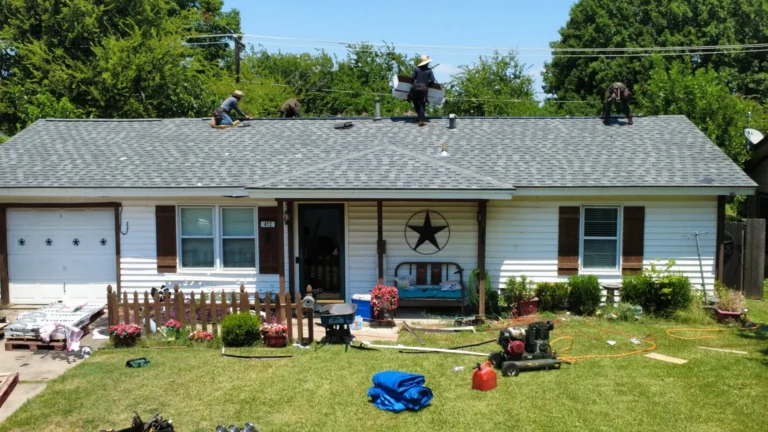 Roofing crew installing shingles